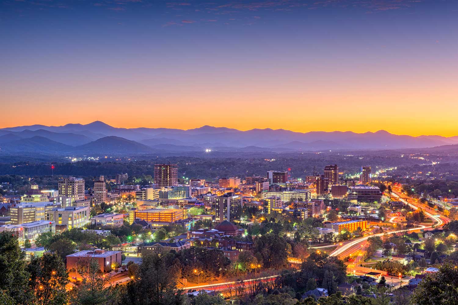 a view on the city and mountains from above at night