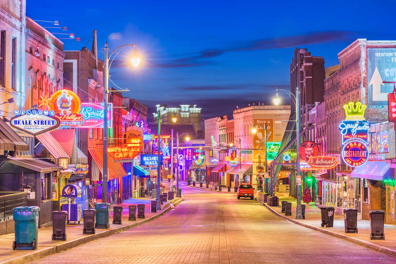 a city street with neon signs on at night