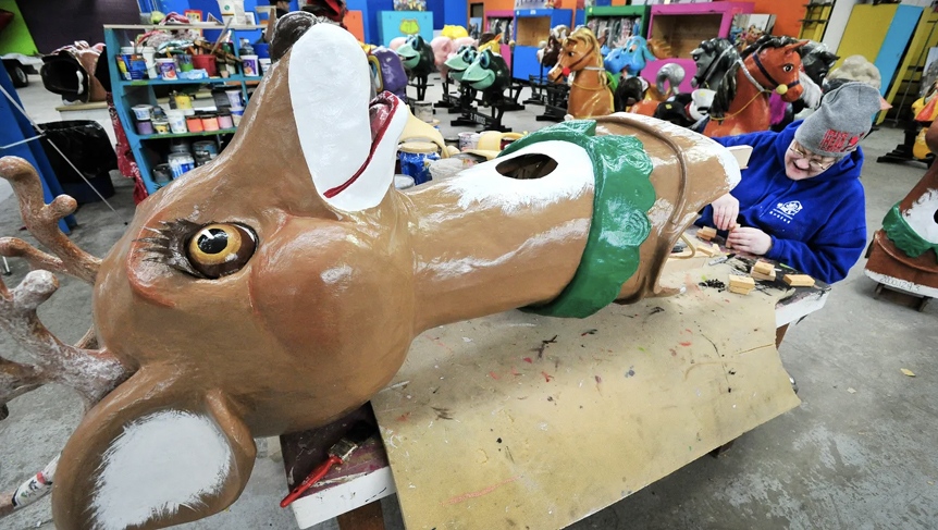 a worker is constructing the plastic christmas deer head