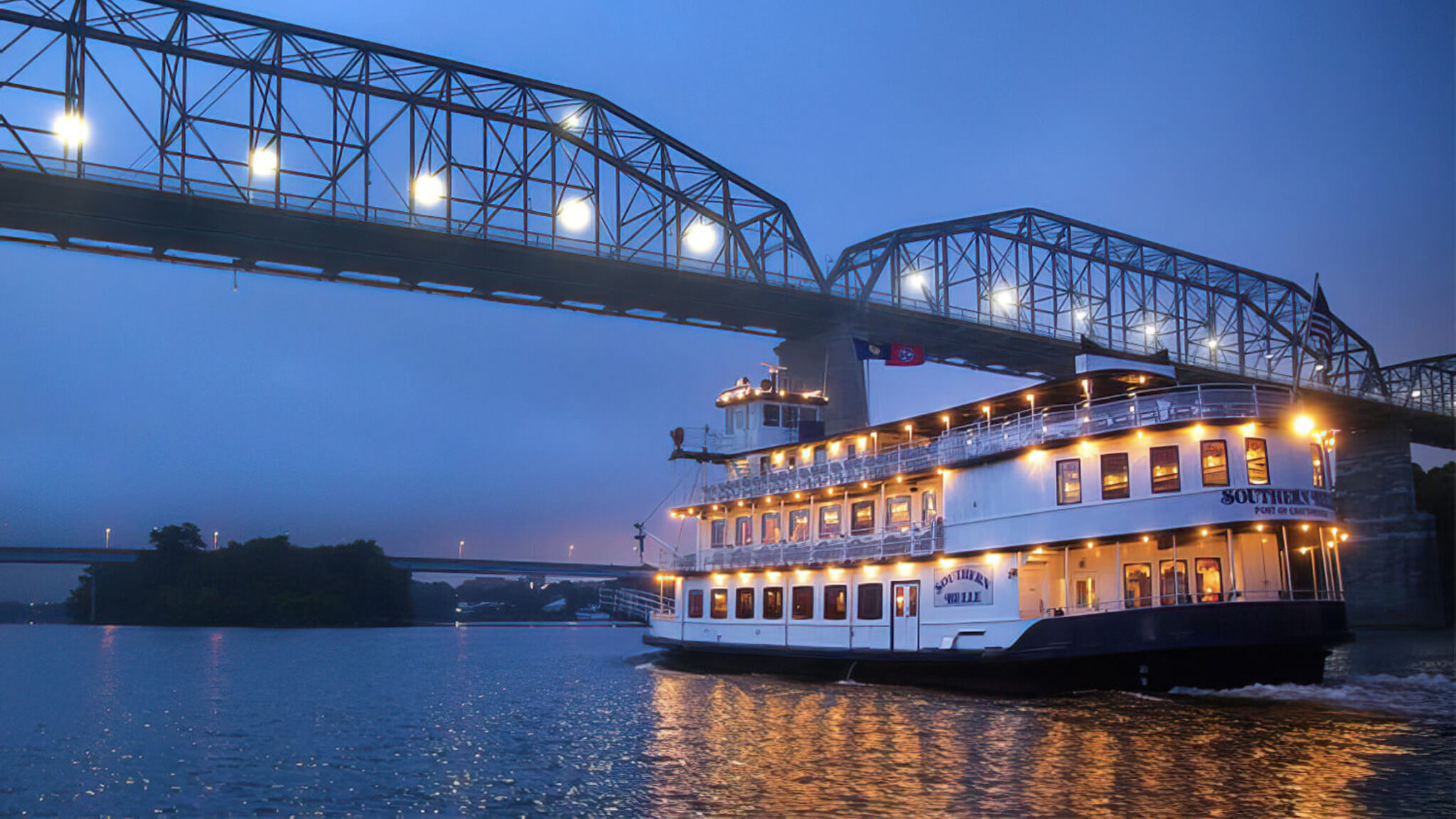 river cruise boat going under the bridge