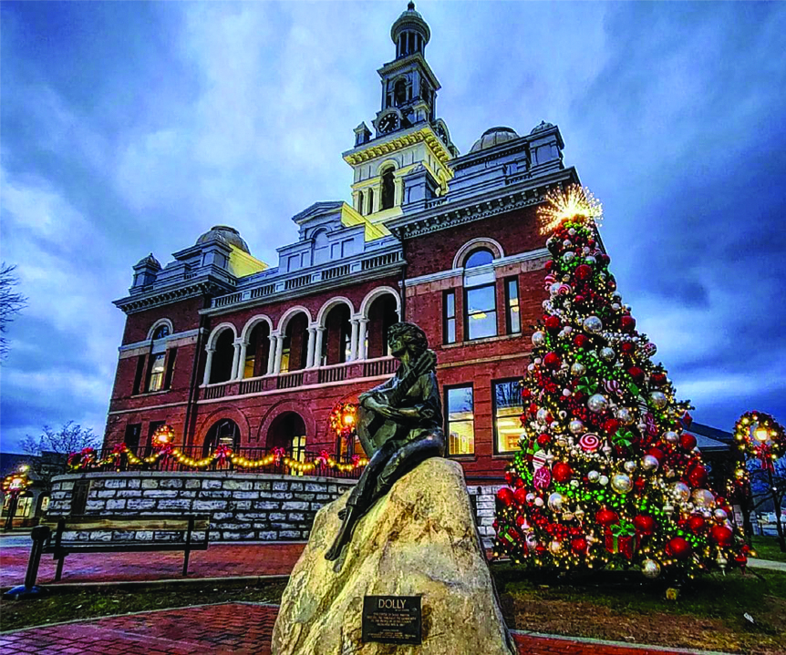 dolly parton statue in front of the christmas tree