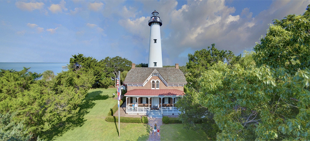 a house in front of the lighthouse