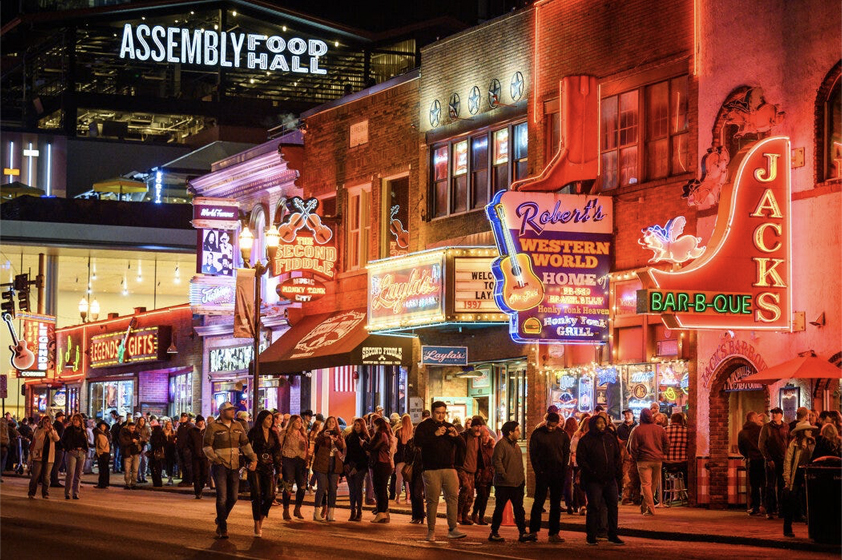 the strip in Nashville at night with neon signs on