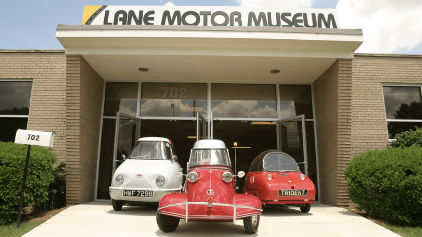 lane motor museum exterior with three retro cars in front of it