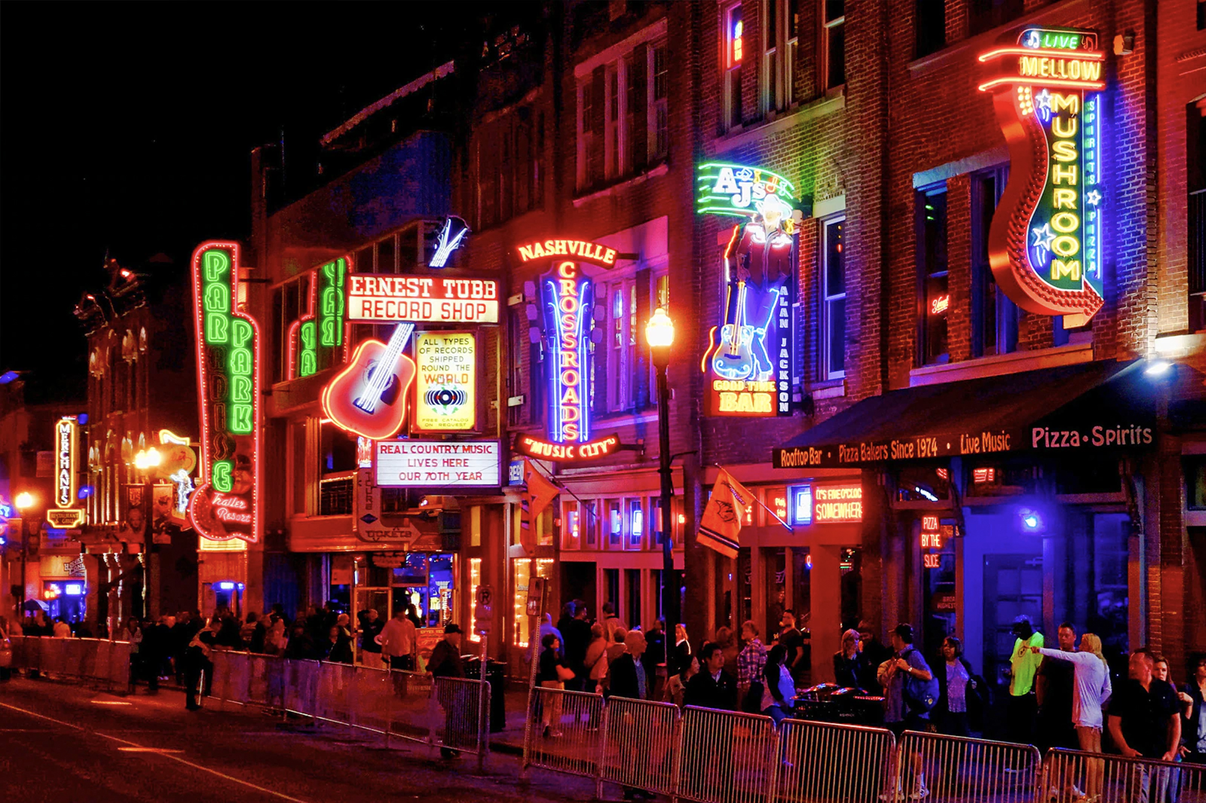 the strip in Nashville at night with neon signs on