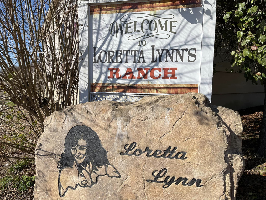 Welcome to Loretta Lynn's sign and a stone