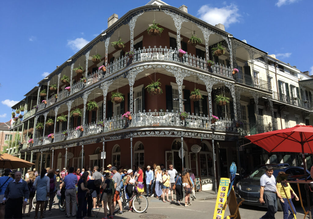 a crowded street in New Orleans with the multi stored building