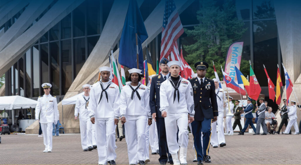 a group of people in navy uniform are walking